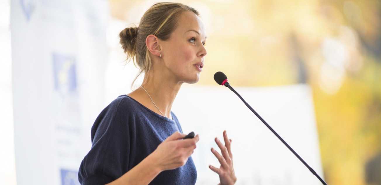 Young business woman giving a presentation in a conference setting