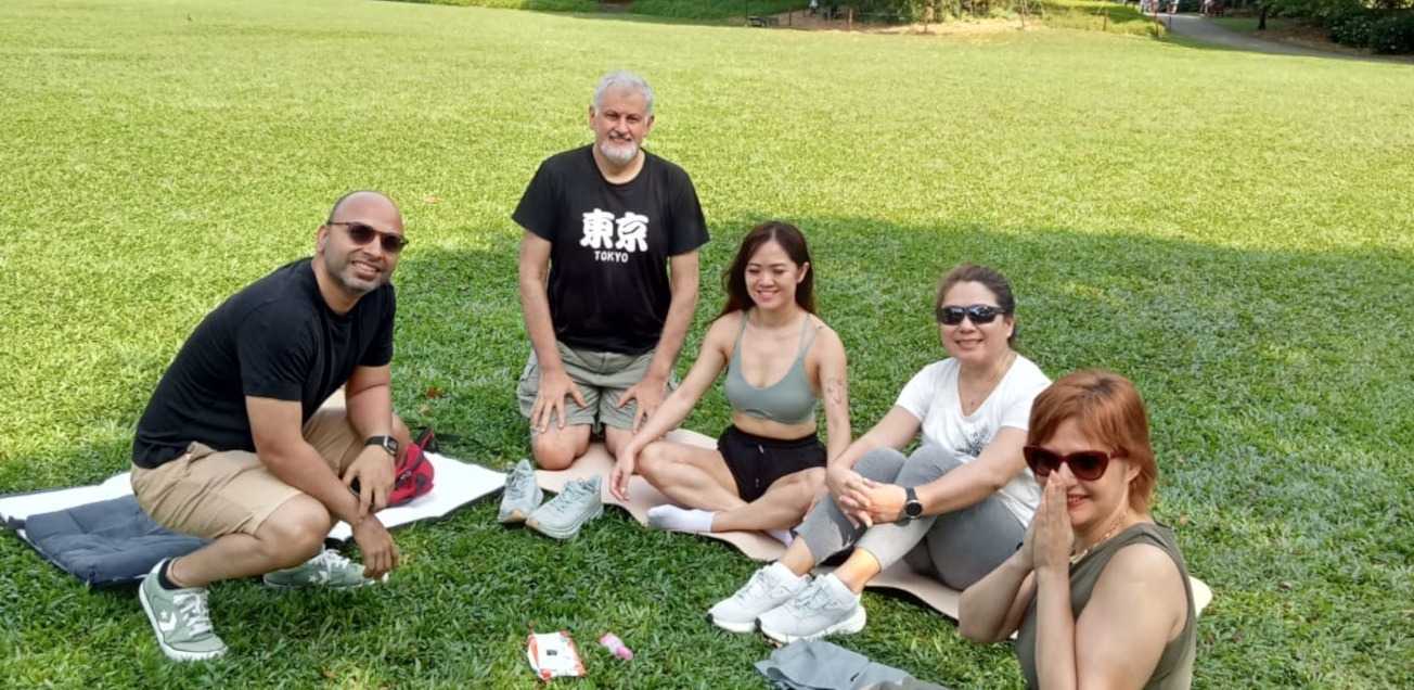 Group picture of members of the Singapore Wellness & Health Group in the park